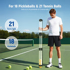A boy is standing on a tennis court holding a NEEWER PB01S Tennis Ball Picker Upper Tube